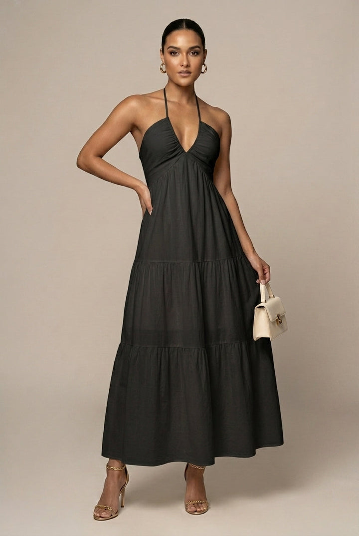 Sophisticated women's maxi dress, halter neck, tiered skirt, open back, ideal for formal summer occasions.