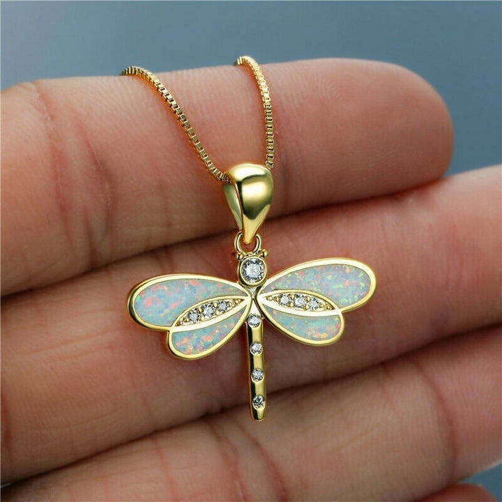 Elegant women's handmade golden dragonfly necklace featuring a shimmering opal gemstone. Perfect luxury nature jewelry.