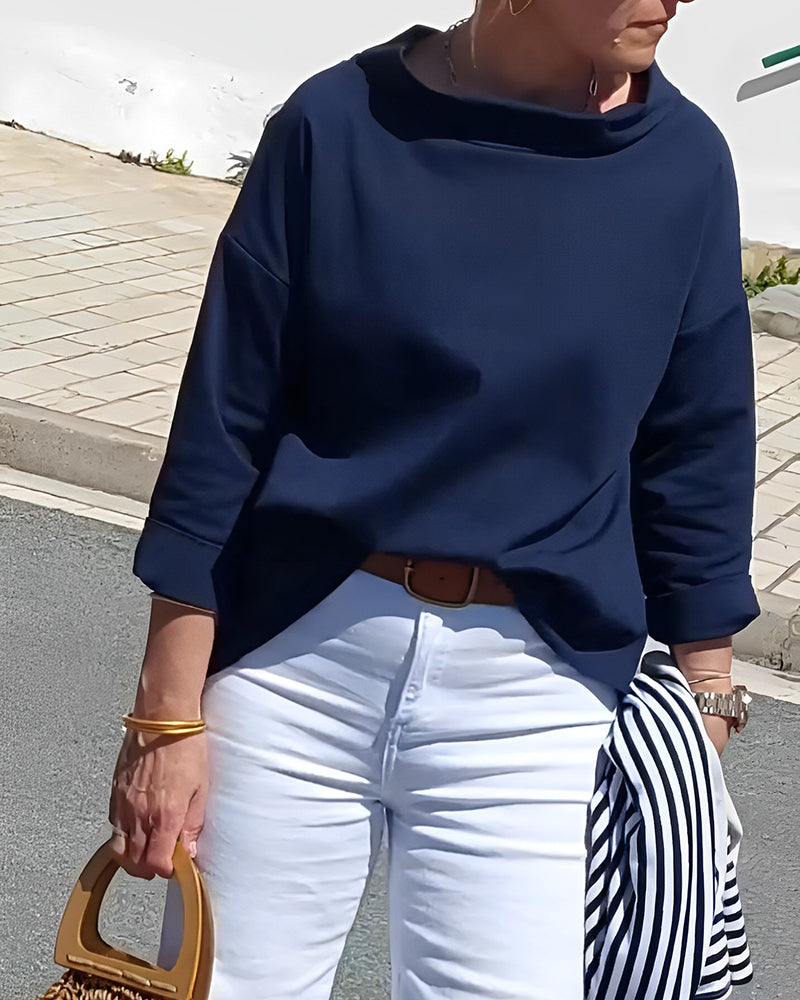 Woman wearing a versatile high-collar long-sleeve top, perfect for casual or formal elegant everyday wear.