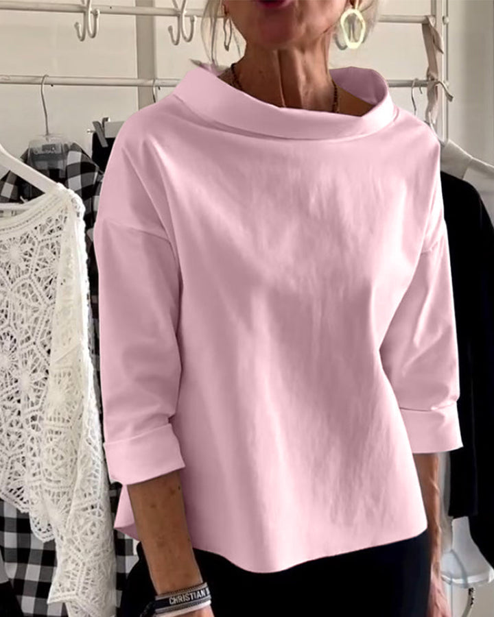 Close-up of the elegant high-collar detail on a women's versatile long-sleeve top, comfortable fabric.