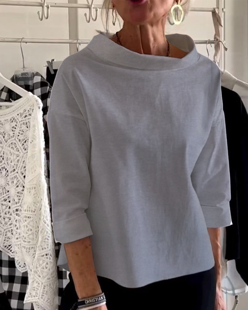 Back view of women's comfortable long-sleeve high-collar top, elegant and versatile for any occasion.