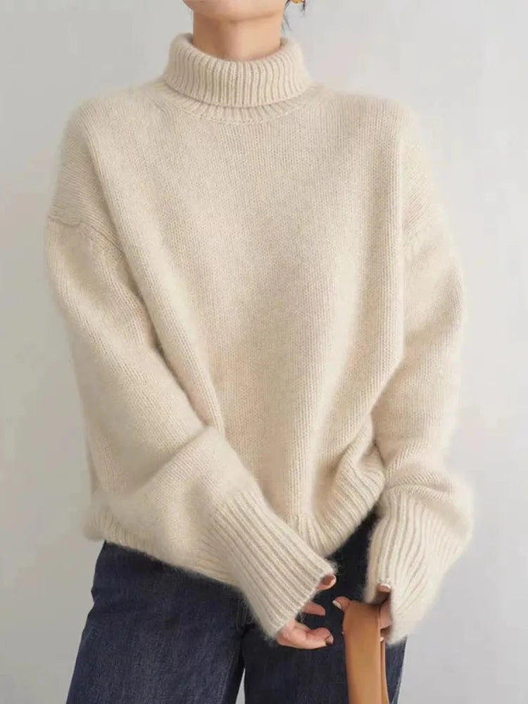 Cozy women's high collar knit sweater, styled for a casual chic look, perfect for autumn layered outfits.