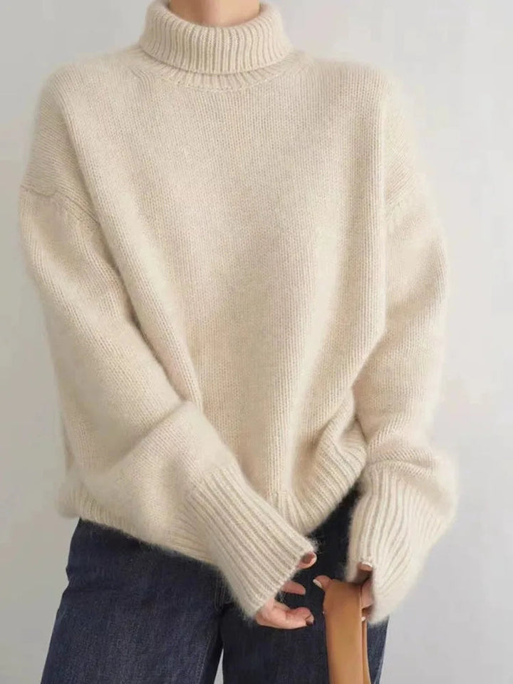 Chic women's turtleneck sweater in a versatile neutral color, featuring a cozy relaxed fit for everyday style.