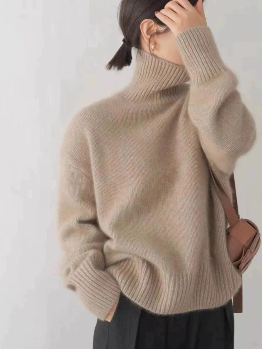 Cozy women's relaxed fit high-neck sweater in a classic knit, offering warmth and timeless style for winter.