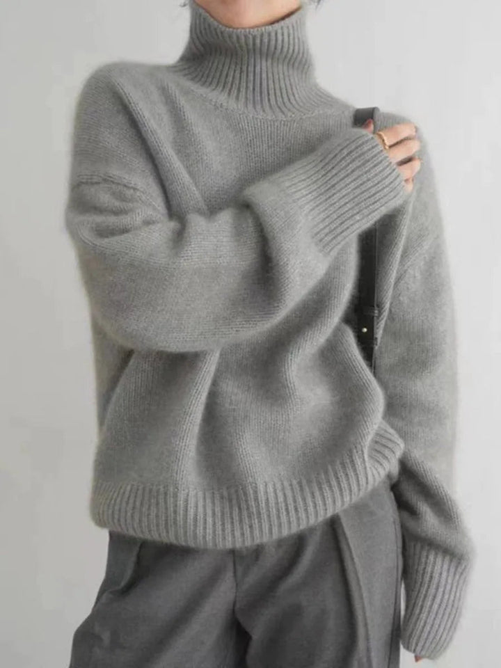Luxurious women's relaxed fit high-neck sweater, perfect for cozy fall afternoons & chic winter fashion.