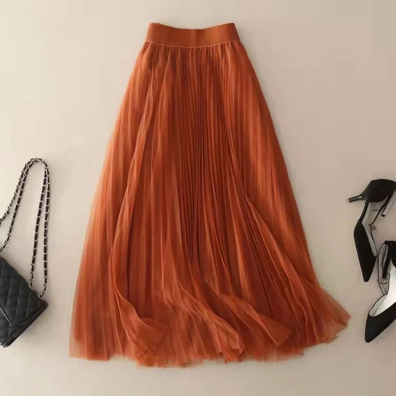 Sophisticated high-waisted pleated midi skirt for women, featuring a graceful flow. Ideal for spring/summer fashion.