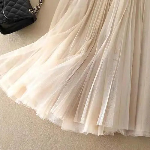 Women's elegant high-waisted pleated midi skirt. This A-line skirt offers a flattering silhouette for all.