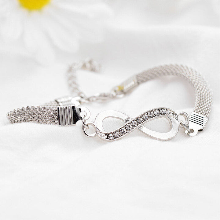 Elegant women's infinity bracelet with sparkling crystals, a timeless silver jewelry piece. Perfect gift for her.