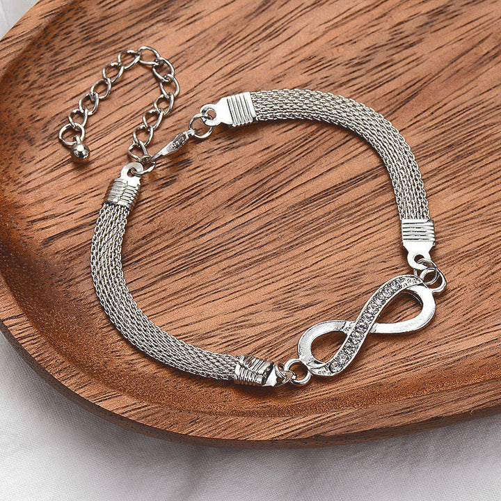 Adjustable silver infinity bracelet for women, adorned with shimmering crystals. Elegant and comfortable jewelry.