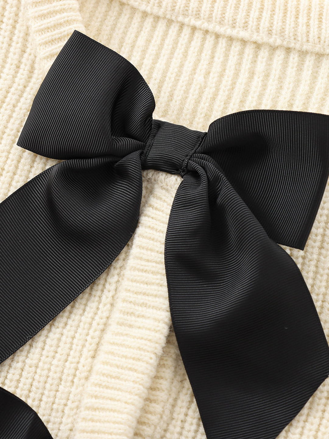 Stylish women's bow sweater, a comfortable and chic knitwear piece for elegant winter fashion.