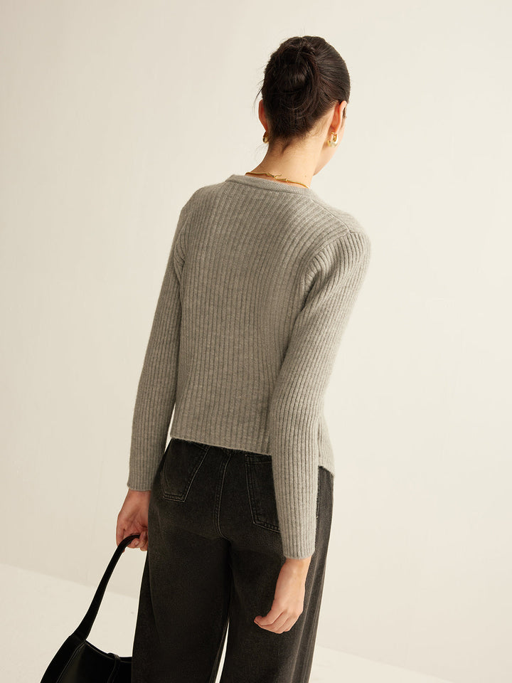 Close-up of a women's button-detail knit sweater, showcasing intricate buttons and soft knitwear texture.