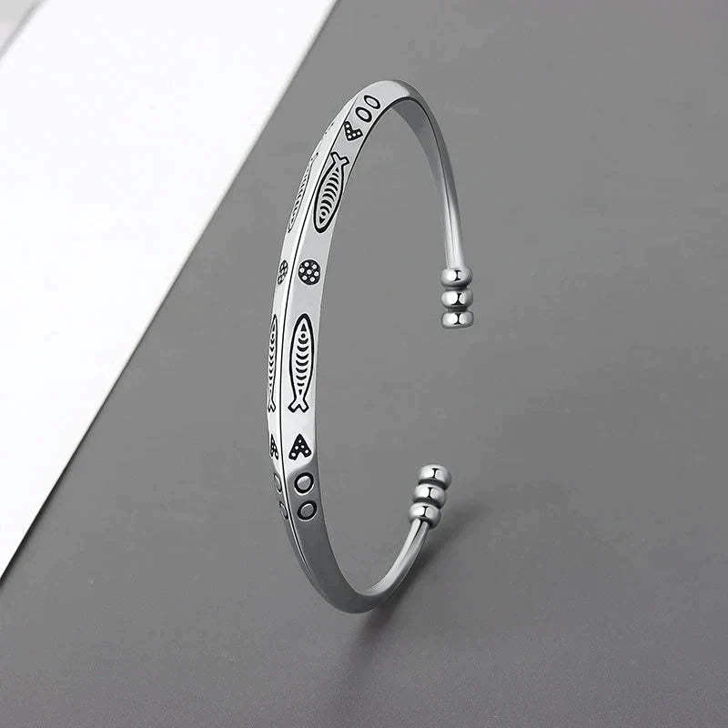 Women's elegant stainless steel koi fish bracelet, adjustable for perfect fit. Symbolic prosperity jewelry.