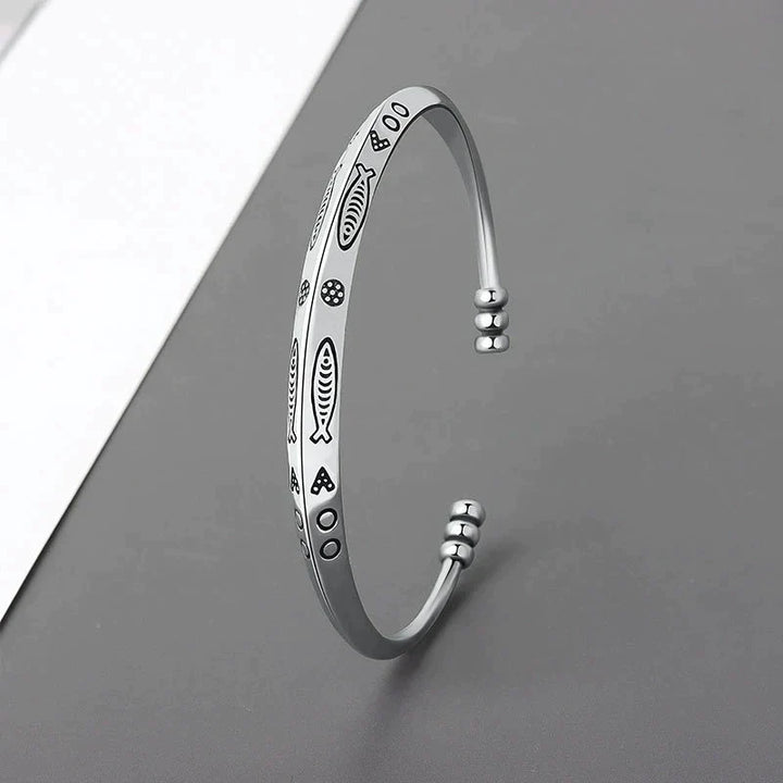Women's elegant stainless steel koi fish bracelet, adjustable for perfect fit. Symbolic prosperity jewelry.