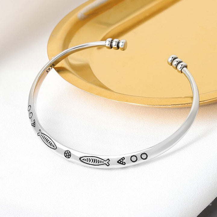Delicate women's prosperity bracelet with elegant koi fish charm. Adjustable stainless steel fortune jewelry.