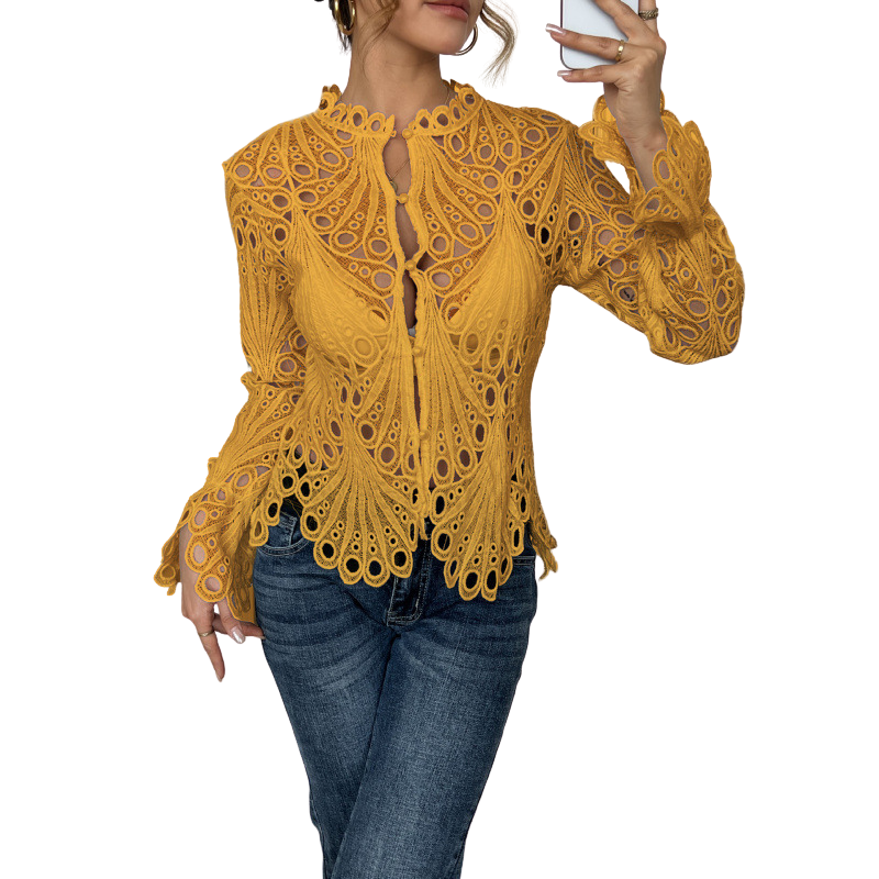 Chic women's lace cutwork top featuring a delicate tie front and scalloped details. Feminine long sleeve blouse.