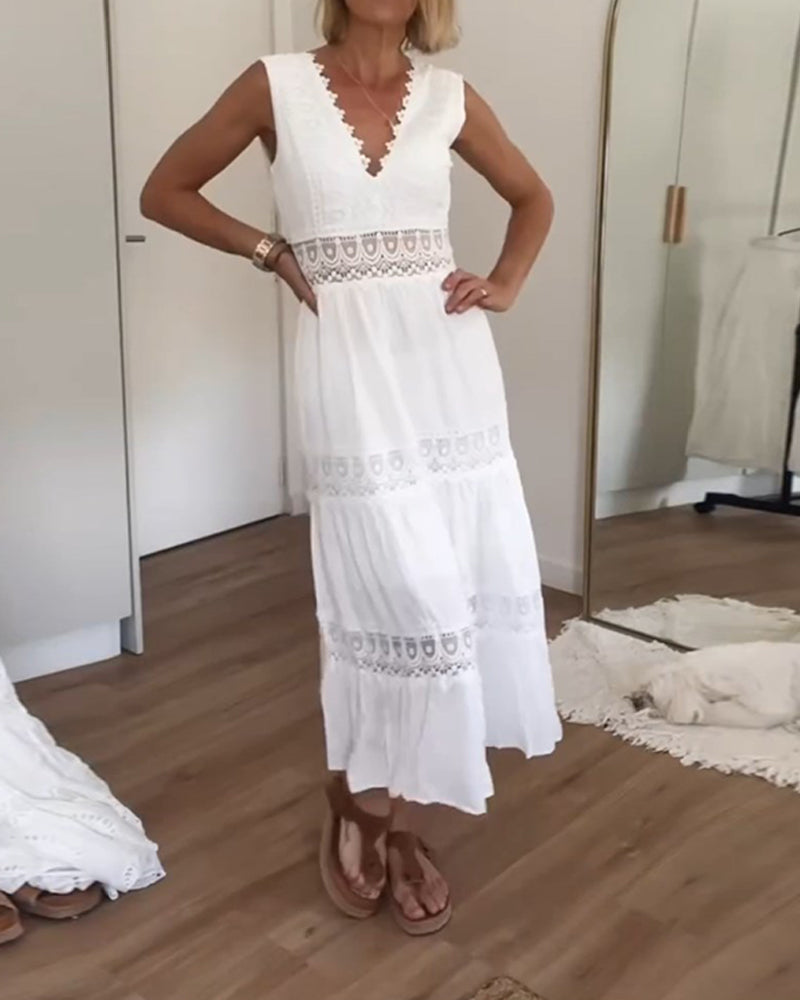 Woman gracefully walking in elegant lace midi dress, sleeveless V-neck, ideal for summer occasions.