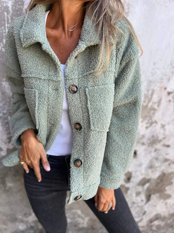 Women's chic short jacket. Elegant lapel collar, comfortable outerwear, a button-front wardrobe essential for autumn.