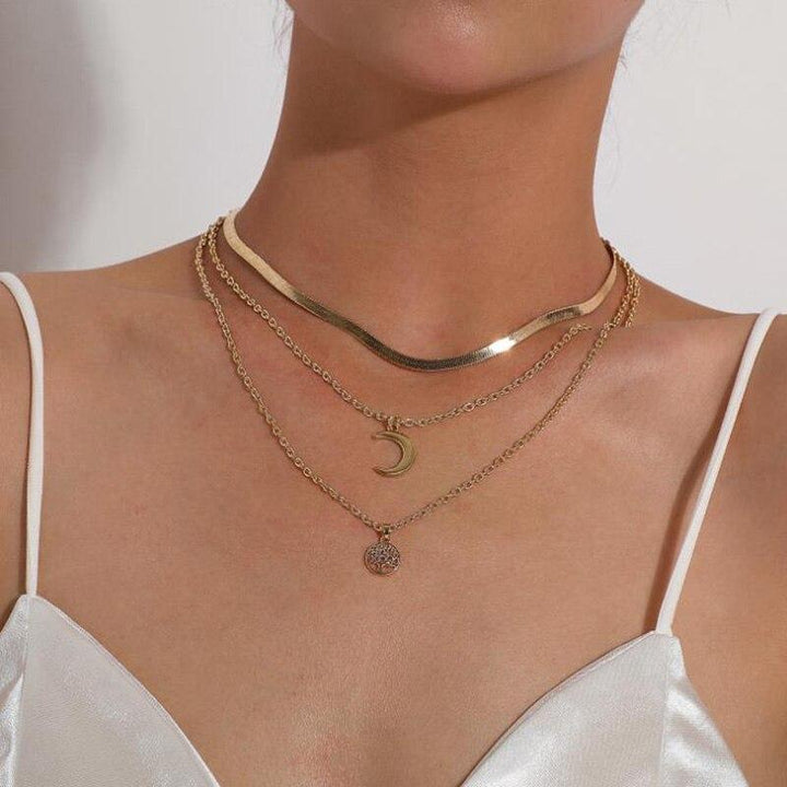 Elegant women's layered necklace with Tree of Life and Half Moon pendants. Celestial & symbolic jewelry.