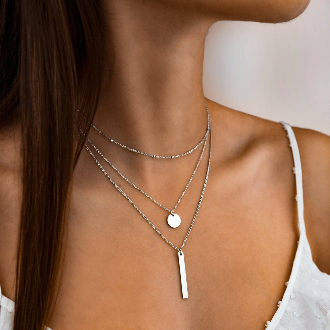 Elegant women's layered triple chain necklace in sterling silver, adjustable for a perfect fit.