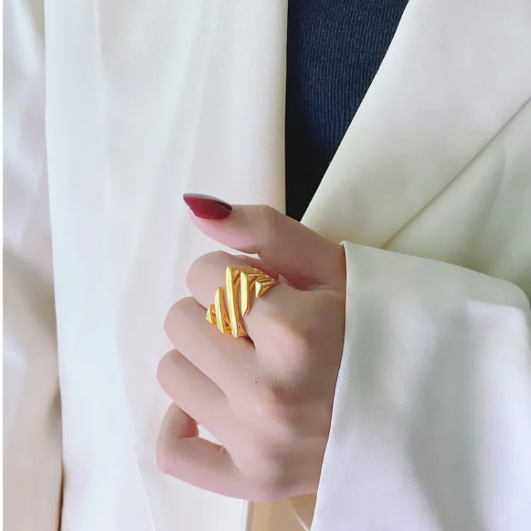 Women's layered twisted fashion ring in gold & silver, an elegant and modern statement jewelry piece.