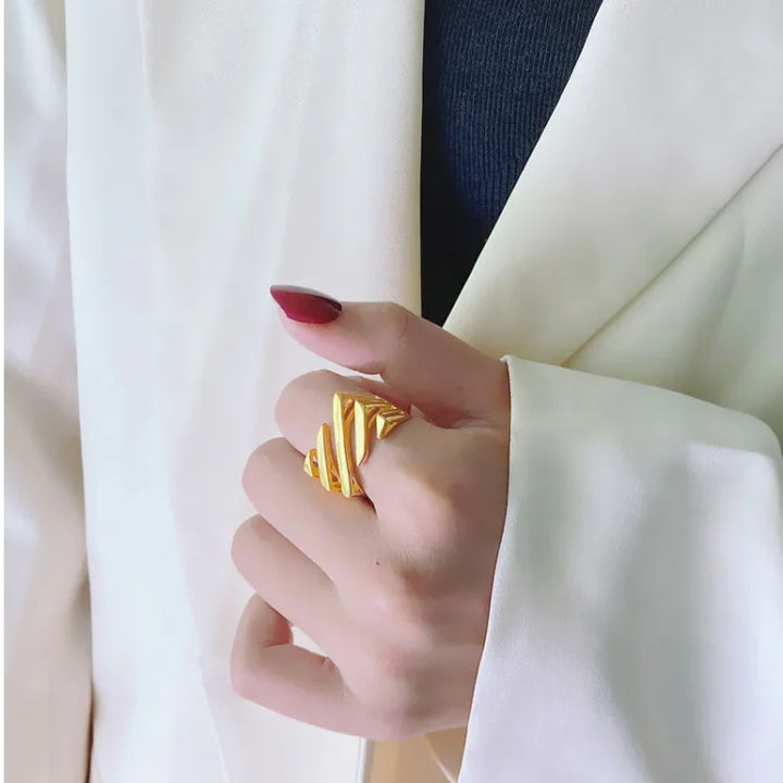 Women's layered twisted fashion ring in gold & silver, an elegant and modern statement jewelry piece.