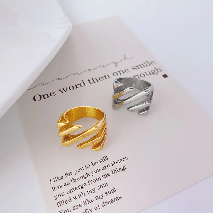 Modern gold & silver plated layered twisted ring for women, elegant fashion jewelry with a unique design.