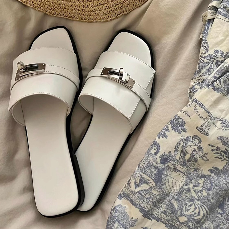 Elegant women's leather square-toe slides with metallic buckle. Chic slip-on summer sandals for casual wear.