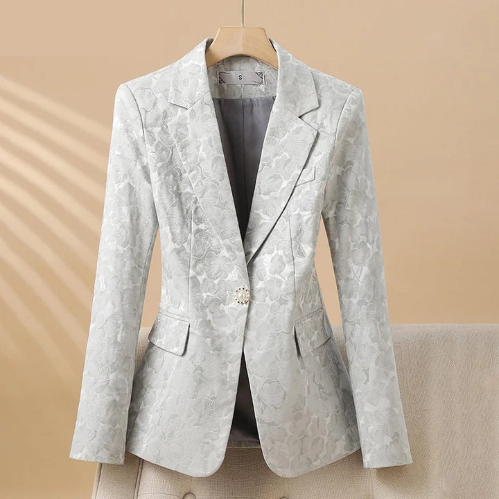 Elegant women's light blue blazer with sophisticated floral texture, perfect for office wear or evening events.