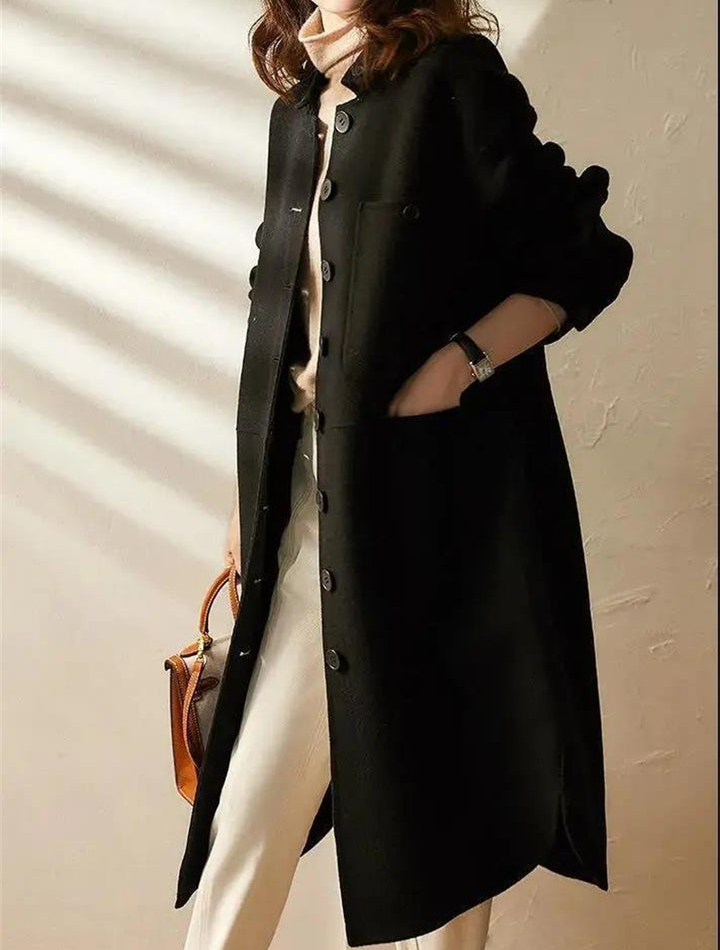 Elegant women's long black trench coat, perfect for versatile casual or formal fall/spring outerwear layering.