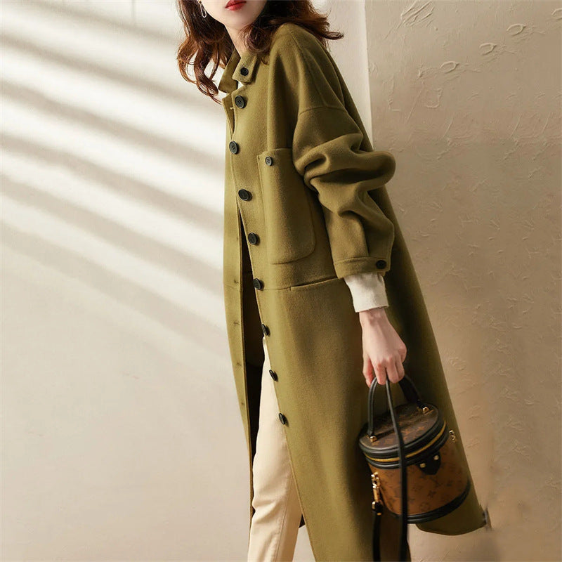 Stylish women's long green trench coat, an elegant outerwear piece for formal or casual spring & fall fashion.