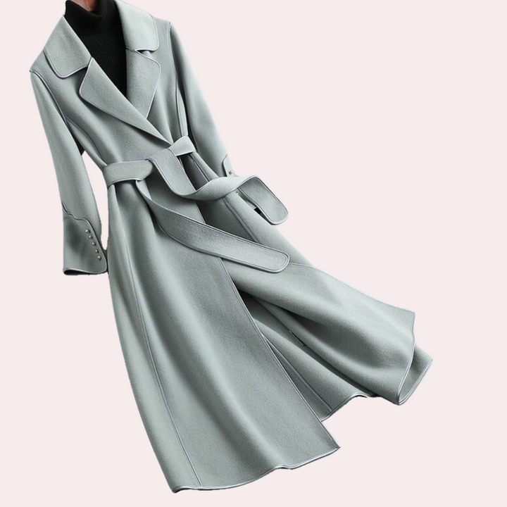Detailed view of a women's long coat. Shows double-button front, notched lapels, and belted waist for a chic look.