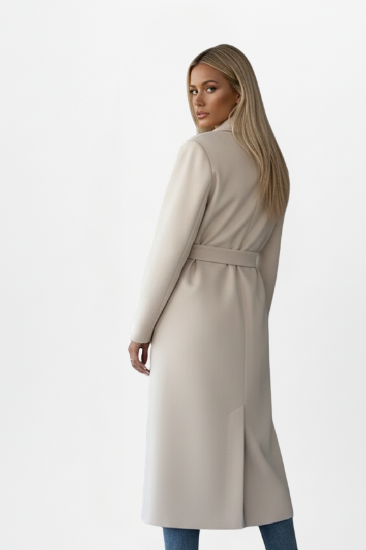 Stylish women's long fall coat. Double-breasted with a chic belt, offering elegant outerwear & sophisticated city fashion.