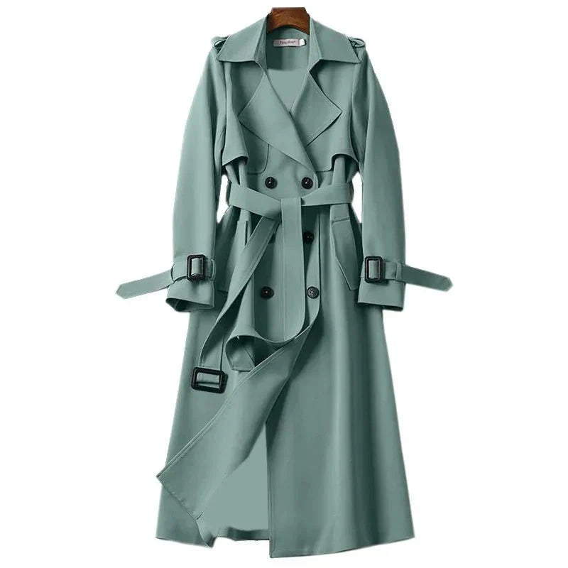 Model in a women's elegant long double-breasted trench coat featuring a sophisticated tie belt.