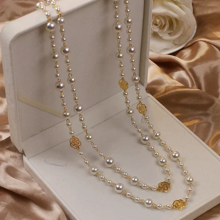 Fashionable women's long pearl necklace featuring elegant white pearls; versatile accessory.