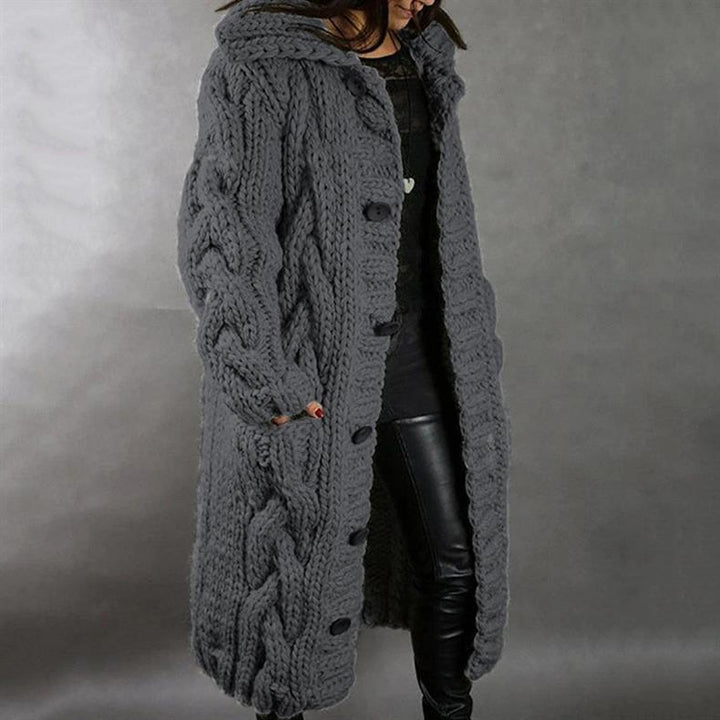 Warm women's grey elegant winter coat. Cozy long outerwear, a stylish and essential piece for cold weather fashion.