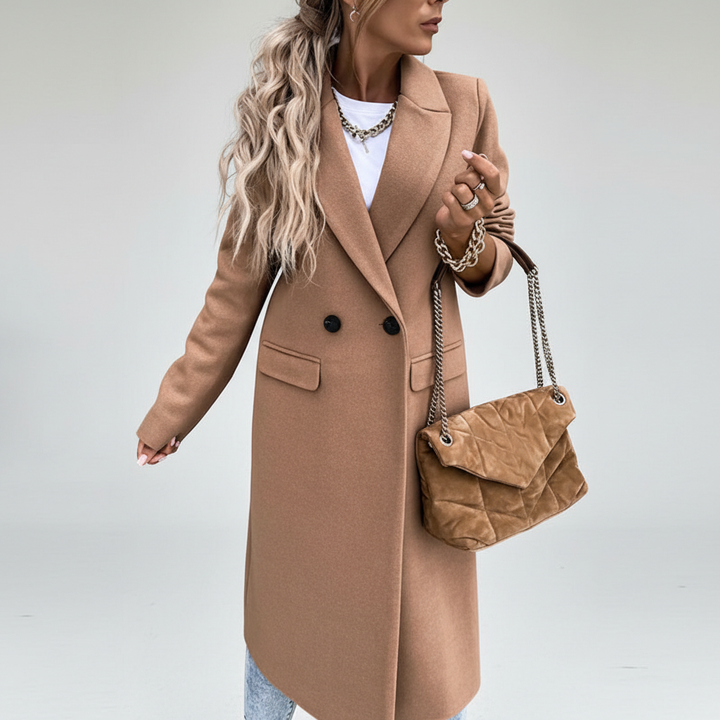Close-up of the button closure on a women's long wool blend coat, highlighting quality and style