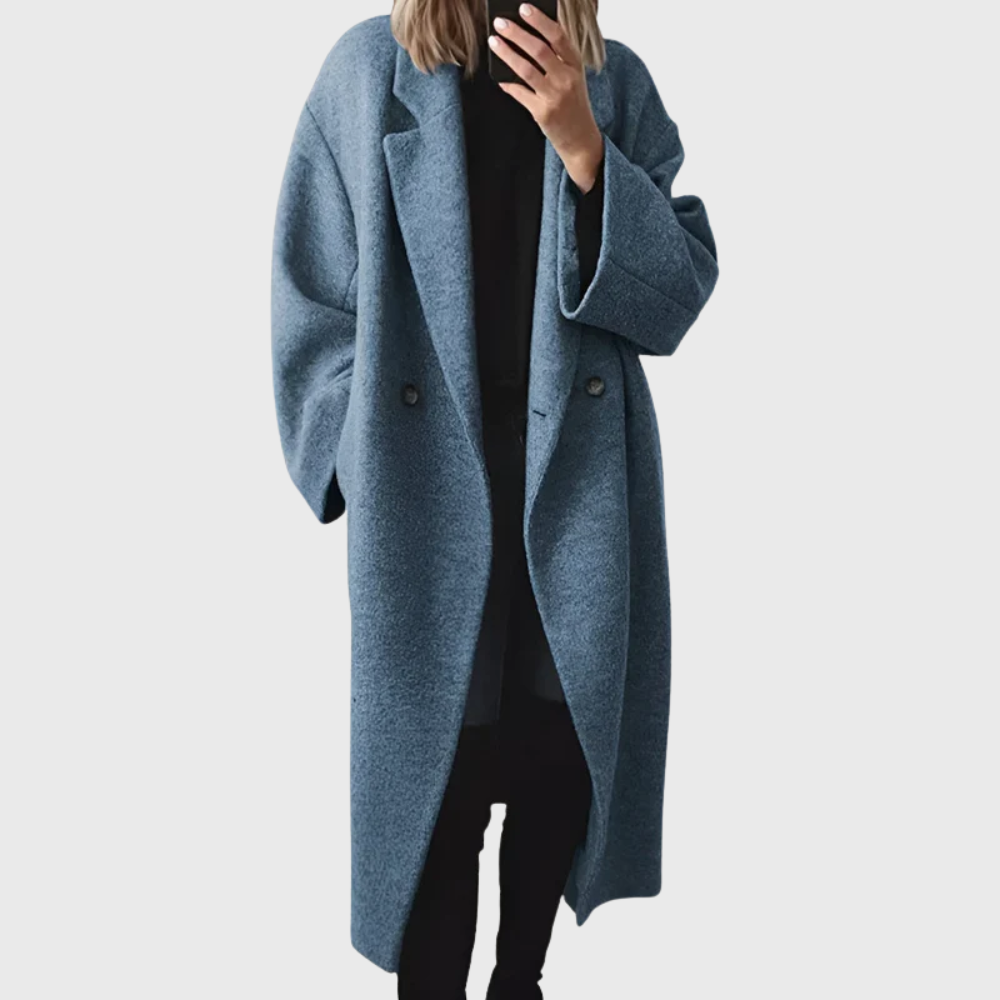 Cozy women's longline blue overcoat, an elegant winter jacket providing warm, stylish protection from the cold.