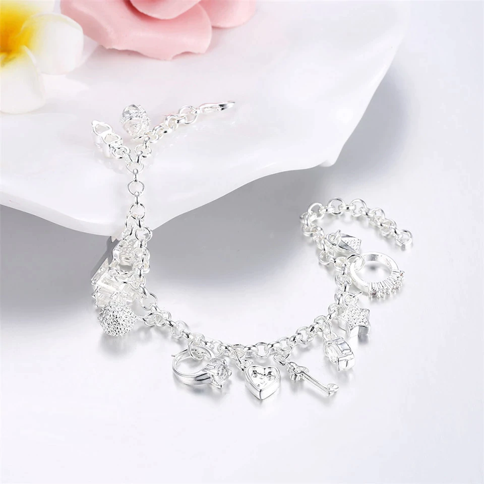 Elegant women's lucky charm bracelet in silver-tone stainless steel. Adjustable, perfect as a fashion accessory.