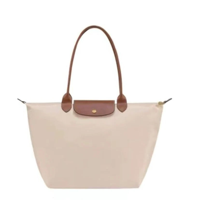Versatile women's elegant top handle bag with shoulder strap, ideal for a chic, luxurious look.