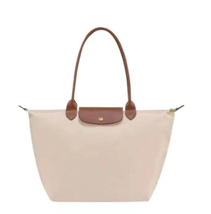 Versatile women's elegant top handle bag with shoulder strap, ideal for a chic, luxurious look.