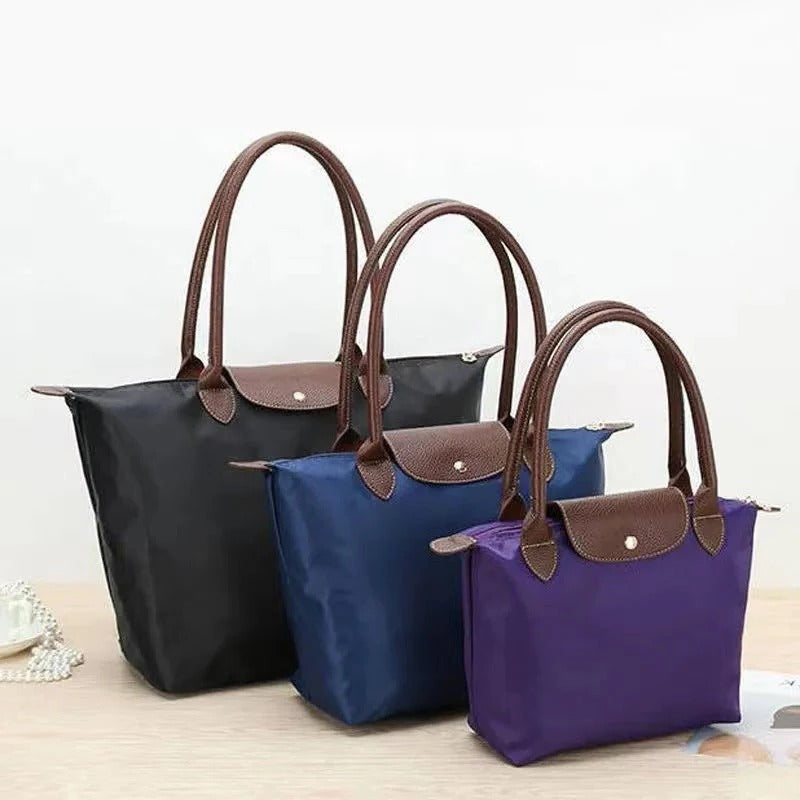 Luxury women's elegant top handle handbag, synthetic leather, a versatile fashion statement accessory.