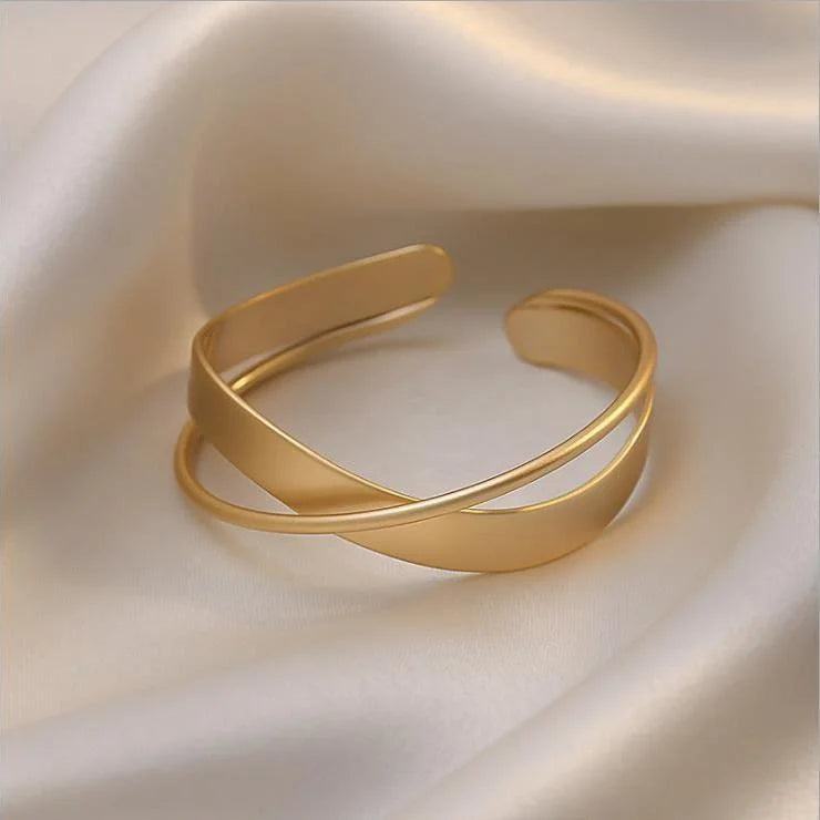 Delicate women's matte gold infinity bracelet, a timeless and elegant wrist accessory for everyday wear or gifting.