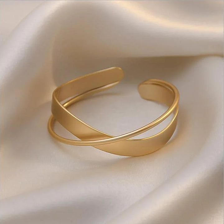 Delicate women's matte gold infinity bracelet, a timeless and elegant wrist accessory for everyday wear or gifting.