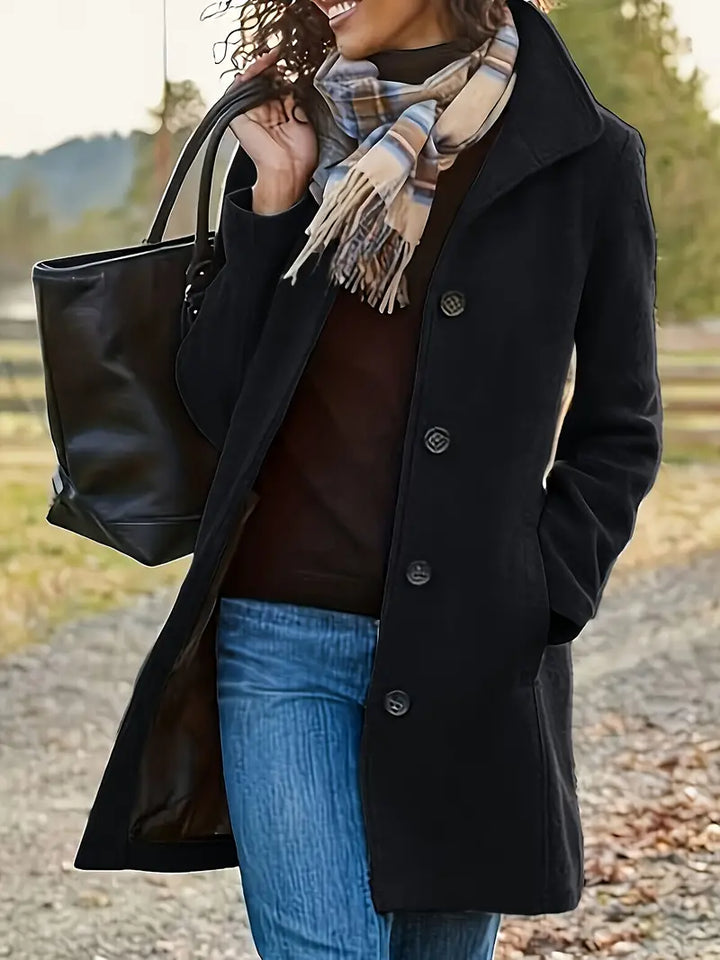 Timeless women's mid-length trenchcoat. Classic lapel & button-front design. Elegant fall/winter outerwear.