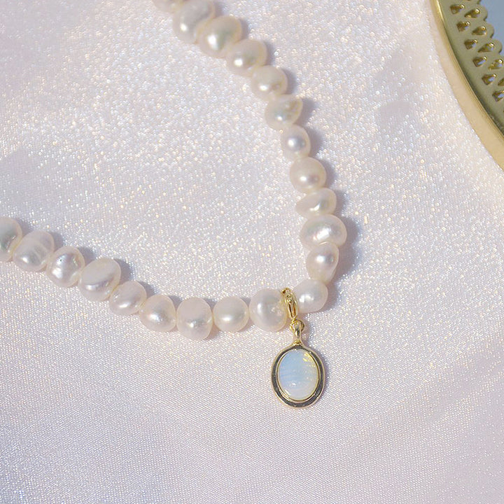Stylish women's mini pearl charm necklace displayed. Short pearl necklace, a delicate and versatile piece of jewelry.