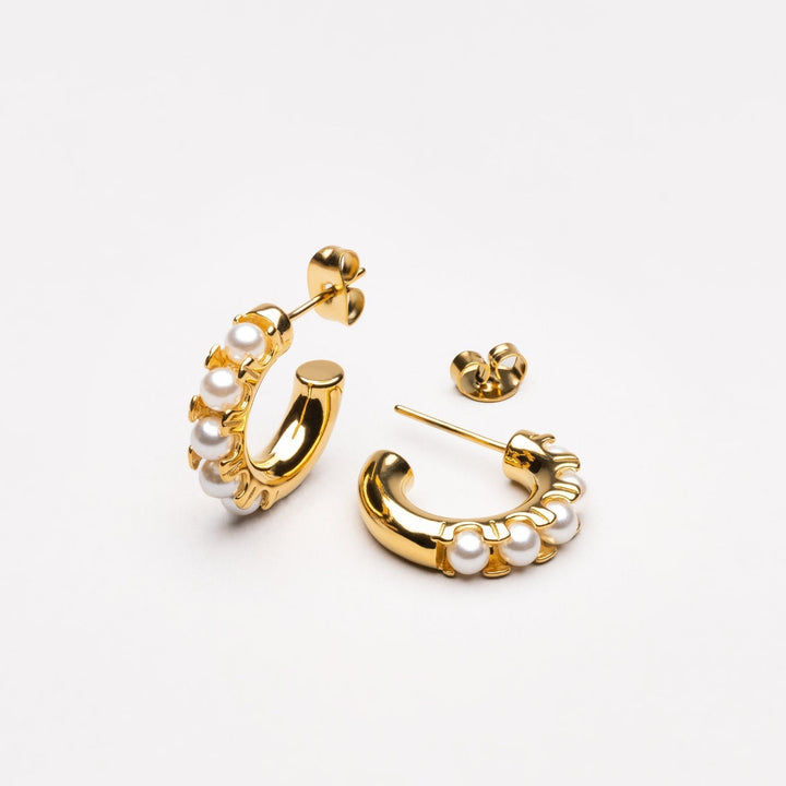 Delicate gold plated mini pearl earrings for women. Water-resistant and hypoallergenic, ideal fashion accessory.