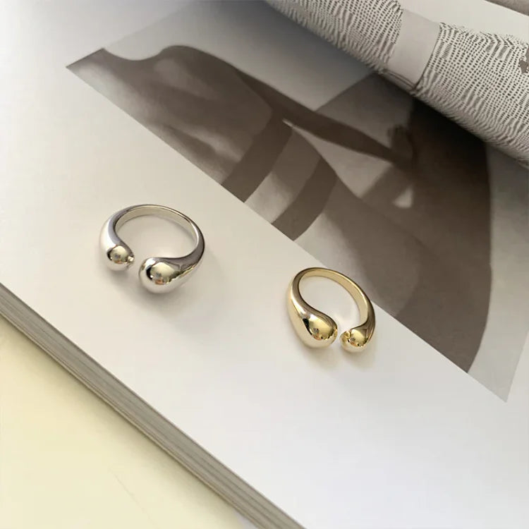 Gold plated women's adjustable ring with a delicate water droplet design, minimalist & elegant. Stackable jewelry.