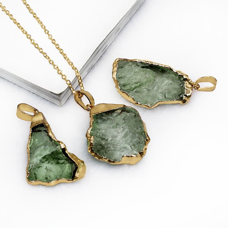 Hand holding a Women's Natural Moldavite necklace, raw cosmic green gemstone pendant. Spiritual jewelry.