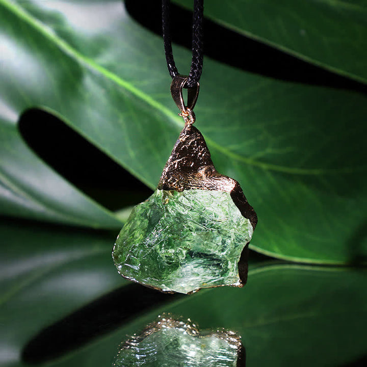 Close-up of a Women's natural Moldavite pendant necklace, showcasing the raw cosmic green gemstone.