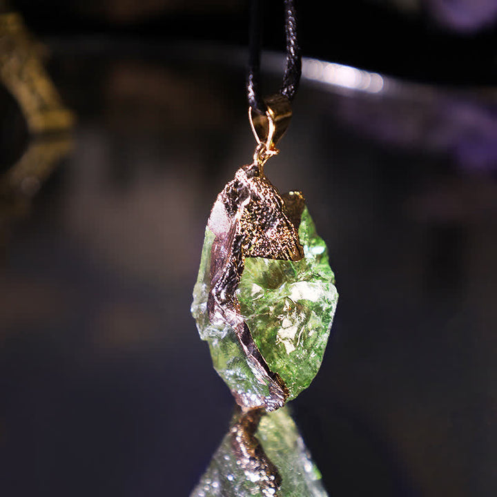 Display of a Women's Natural Moldavite necklace, featuring a raw cosmic green gemstone. Unique gift.